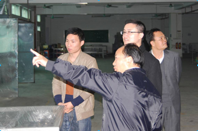 莫校长向邱总介绍车间设备